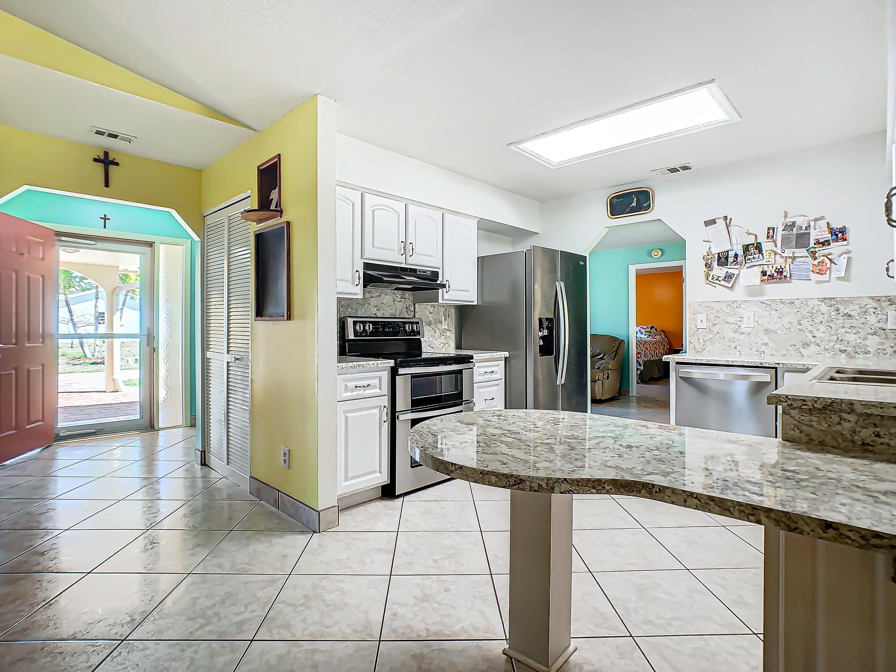 409 Surf Road Melbourne Beach, FL 32951 - Photo 11 of 34 a kitchen with stainless steel appliances granite countertop a stove refrigerator and sink