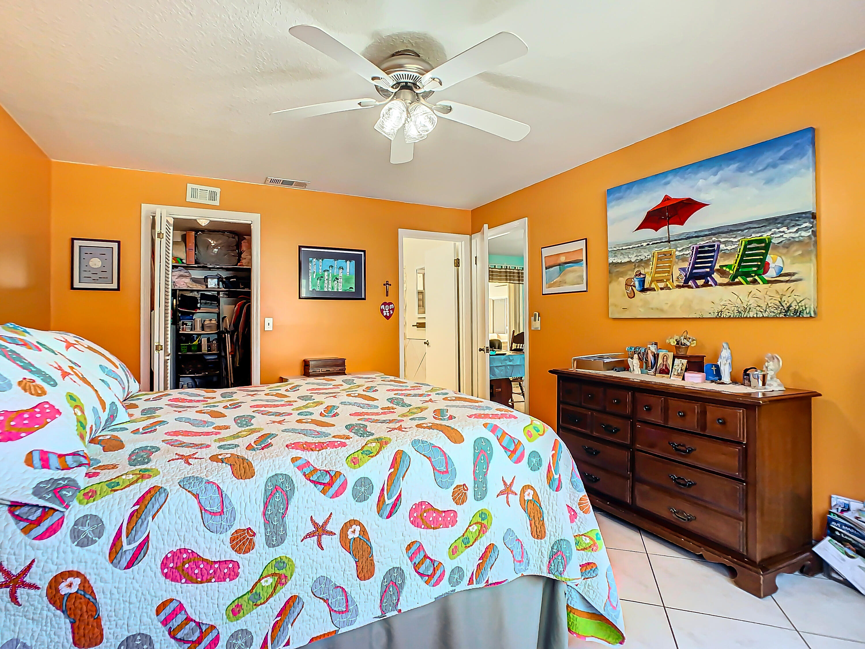 409 Surf Road Melbourne Beach, FL 32951 - Photo 14 of 34 a bedroom with a bed and dresser