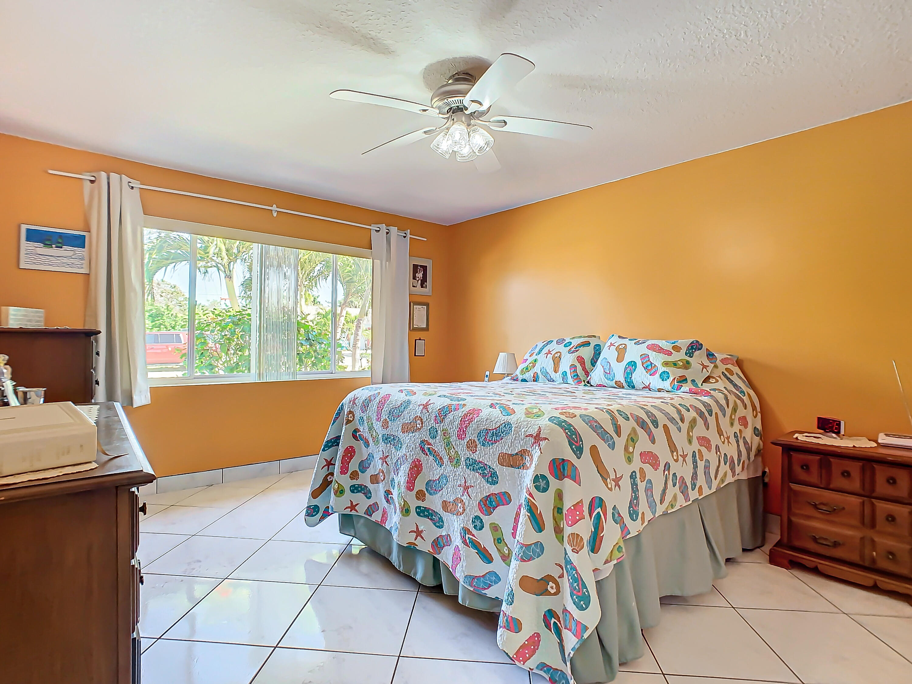 409 Surf Road Melbourne Beach, FL 32951 - Photo 15 of 34 a bedroom with a bed and a window