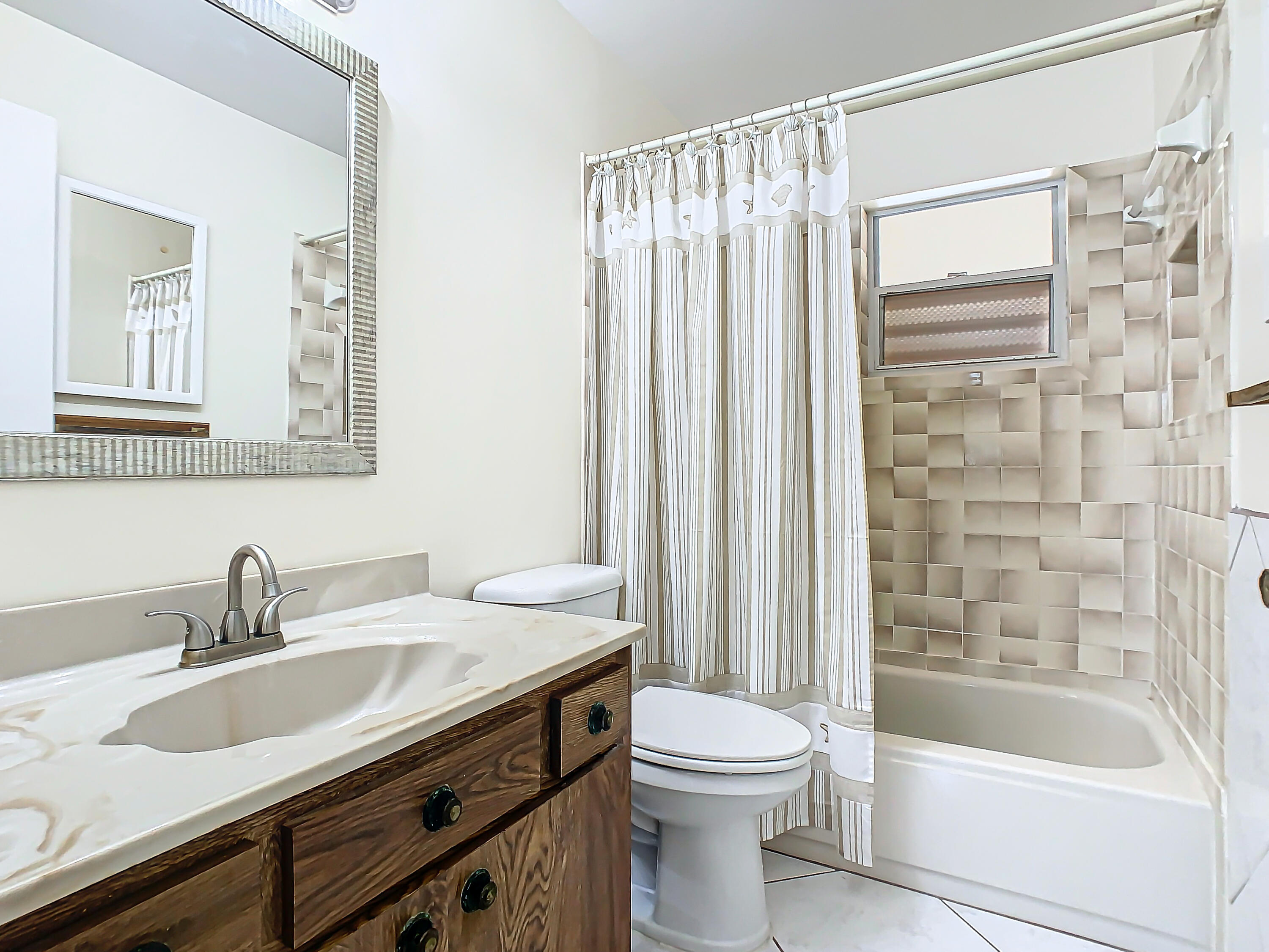 409 Surf Road Melbourne Beach, FL 32951 - Photo 16 of 34 a bathroom with a sink a toilet and a bathtub