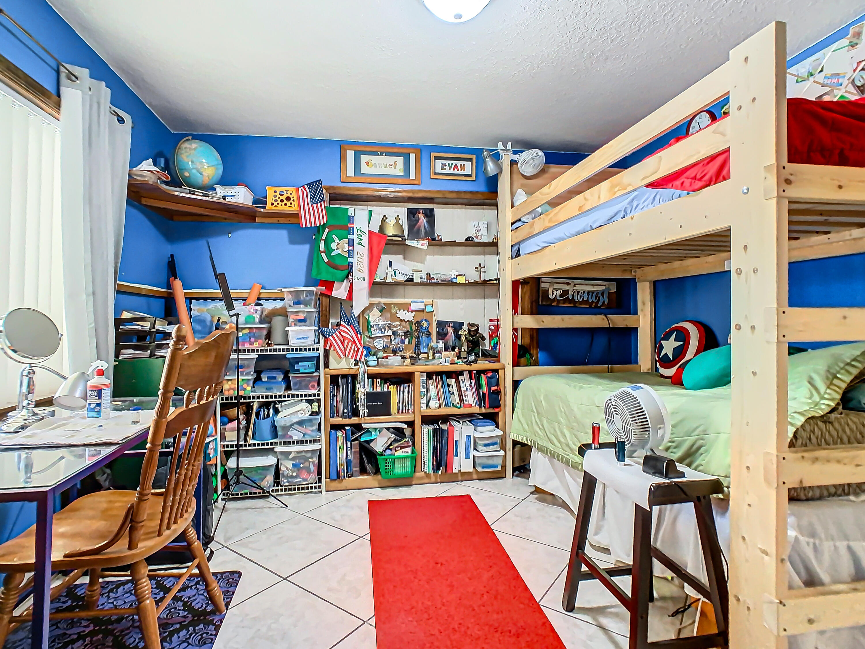 409 Surf Road Melbourne Beach, FL 32951 - Photo 19 of 34 a room that has a bed and a bookshelf in it