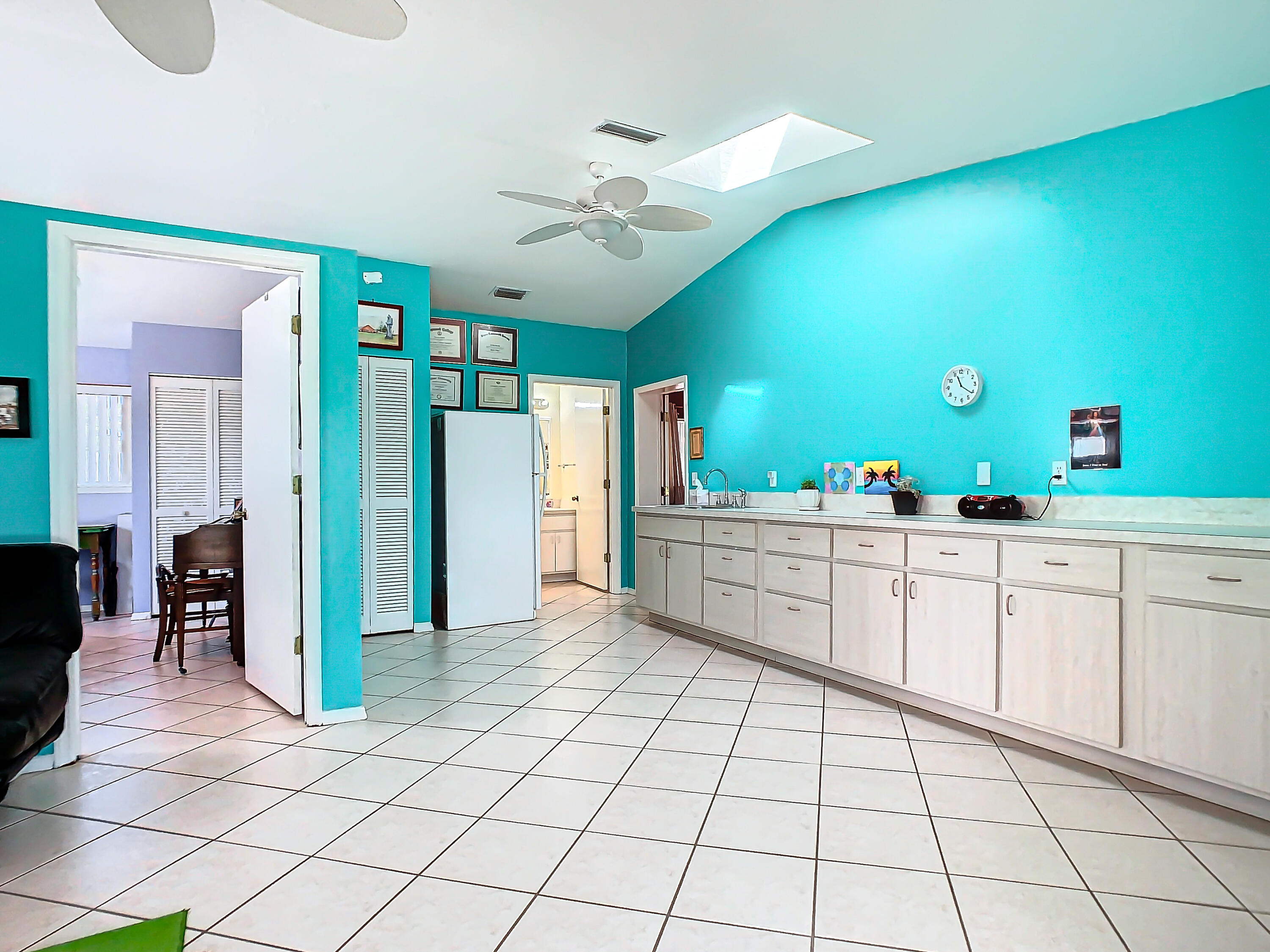 409 Surf Road Melbourne Beach, FL 32951 - Photo 23 of 34 a large white kitchen with a sink and dishwasher