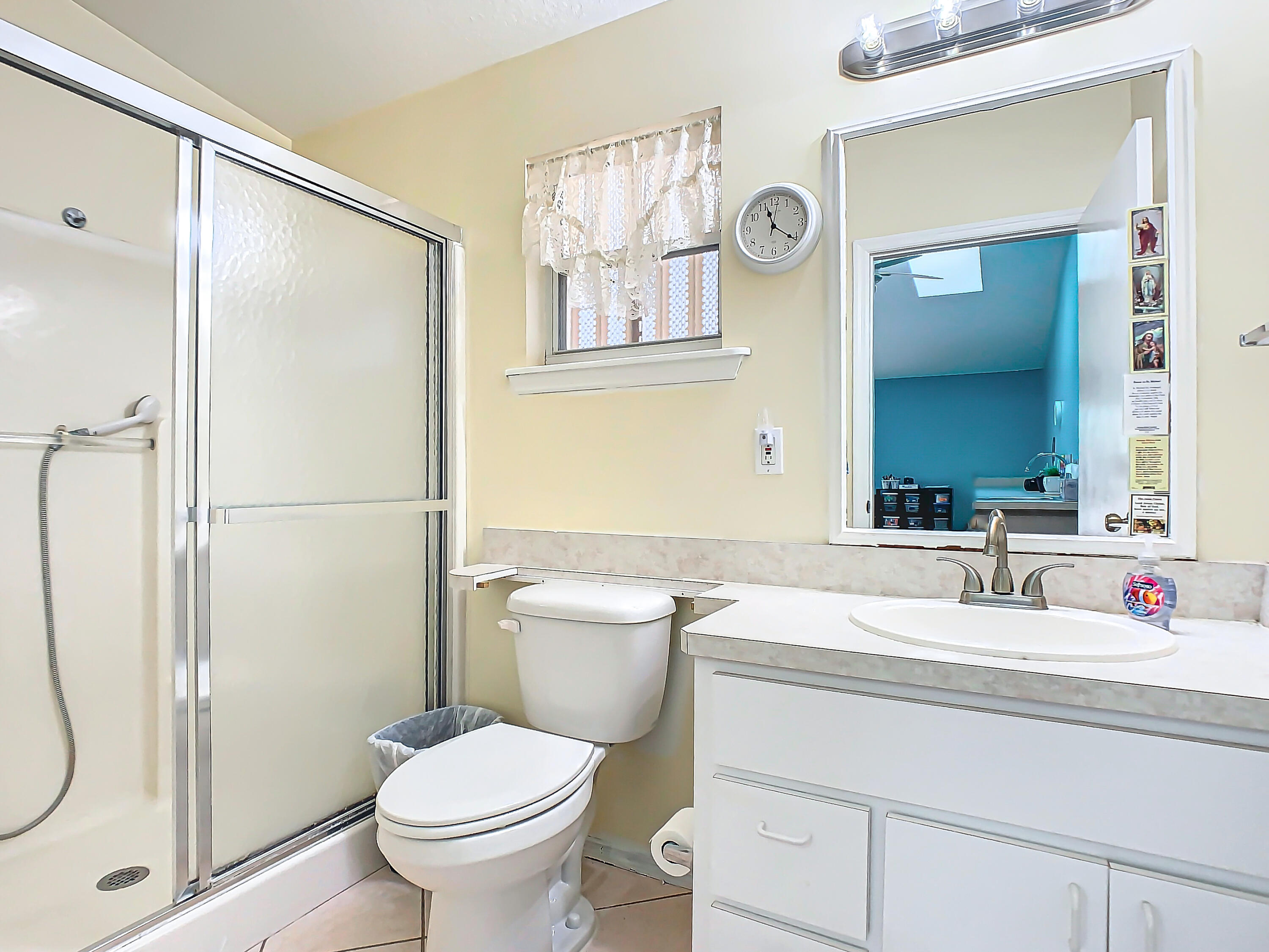 409 Surf Road Melbourne Beach, FL 32951 - Photo 24 of 34 a bathroom with a sink a toilet and a mirror