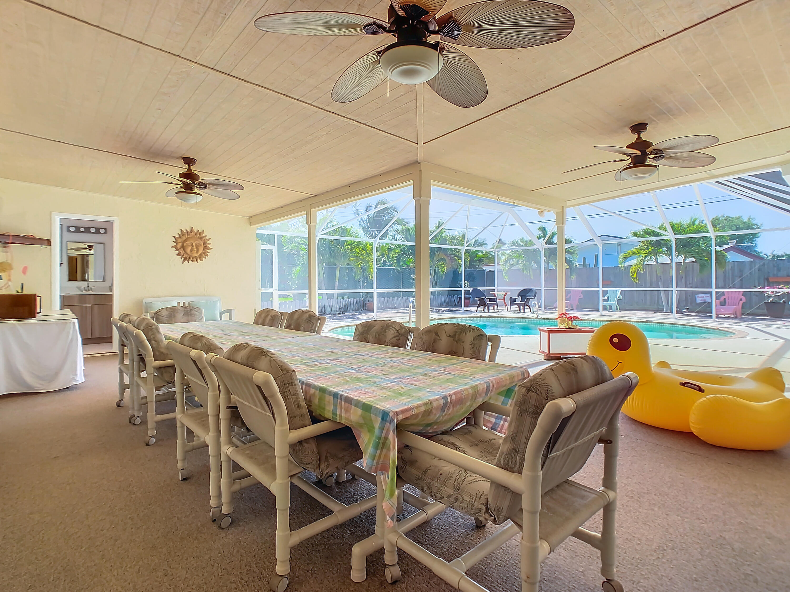 409 Surf Road Melbourne Beach, FL 32951 - Photo 26 of 34 a dining room with a table chairs and a chandelier
