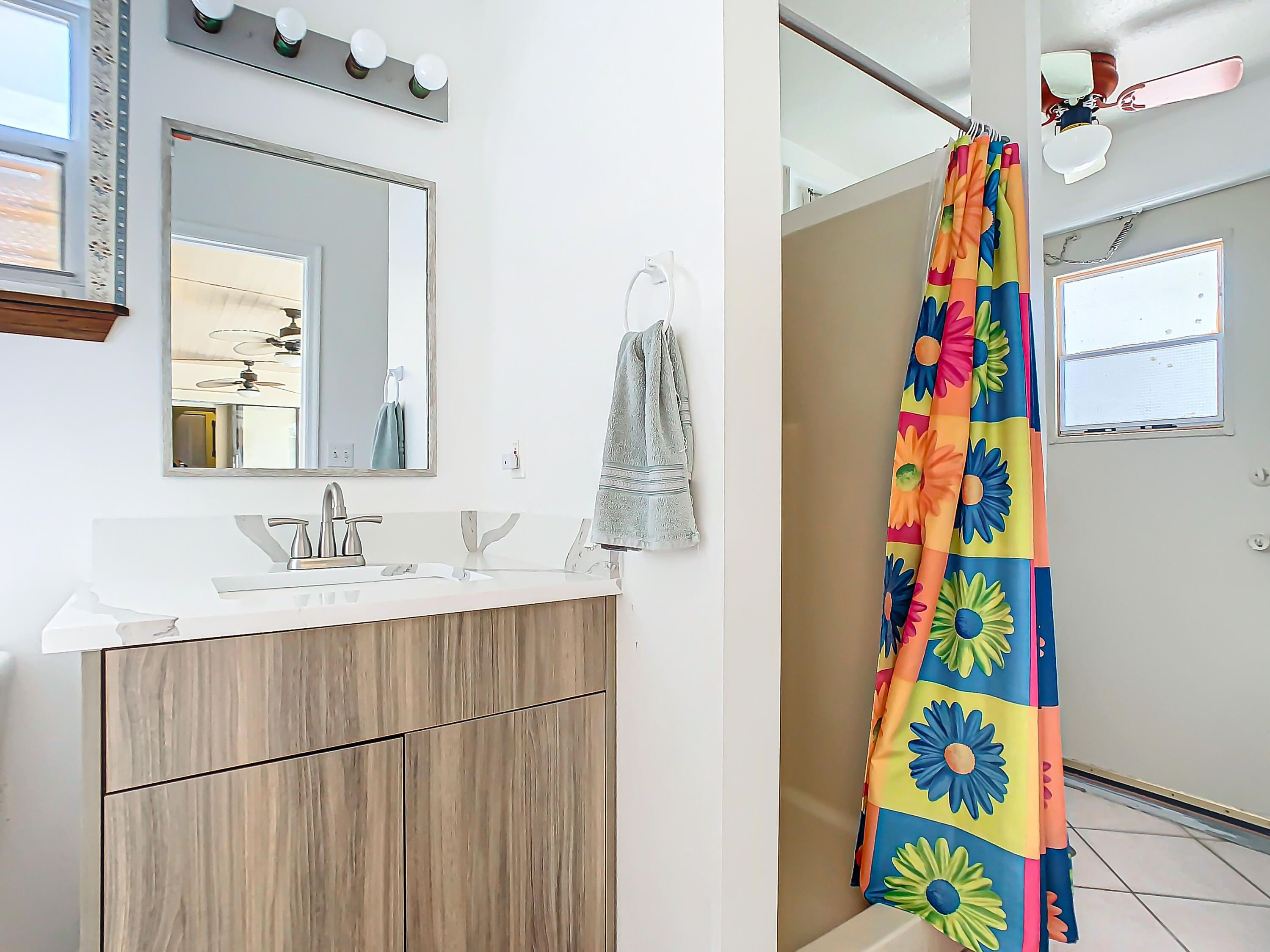 409 Surf Road Melbourne Beach, FL 32951 - Photo 27 of 34 a bathroom with a sink a vanity and a mirror