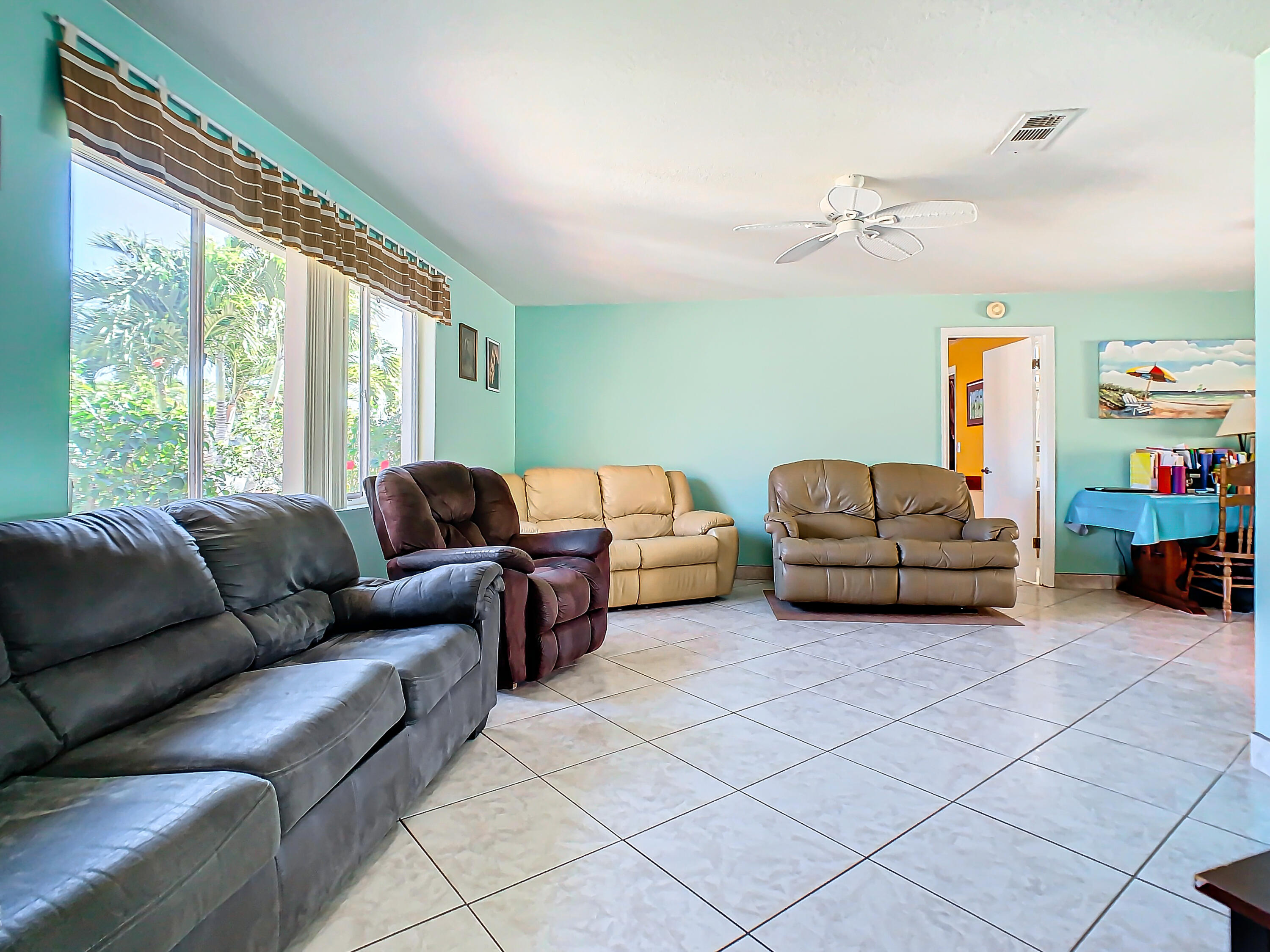 409 Surf Road Melbourne Beach, FL 32951 - Photo 5 of 34 a living room with furniture and a large window
