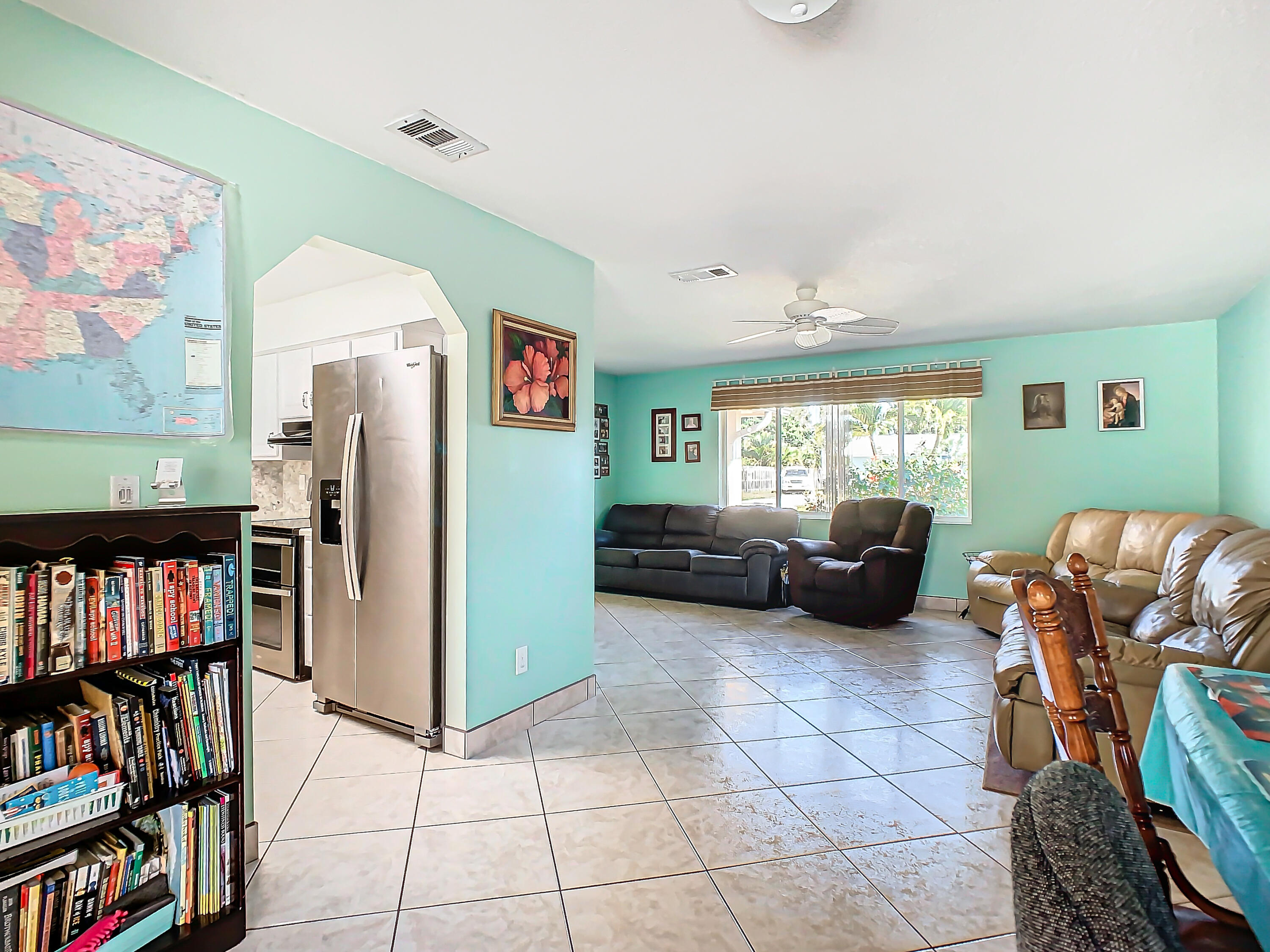 409 Surf Road Melbourne Beach, FL 32951 - Photo 8 of 34 a living room with furniture and a book shelf