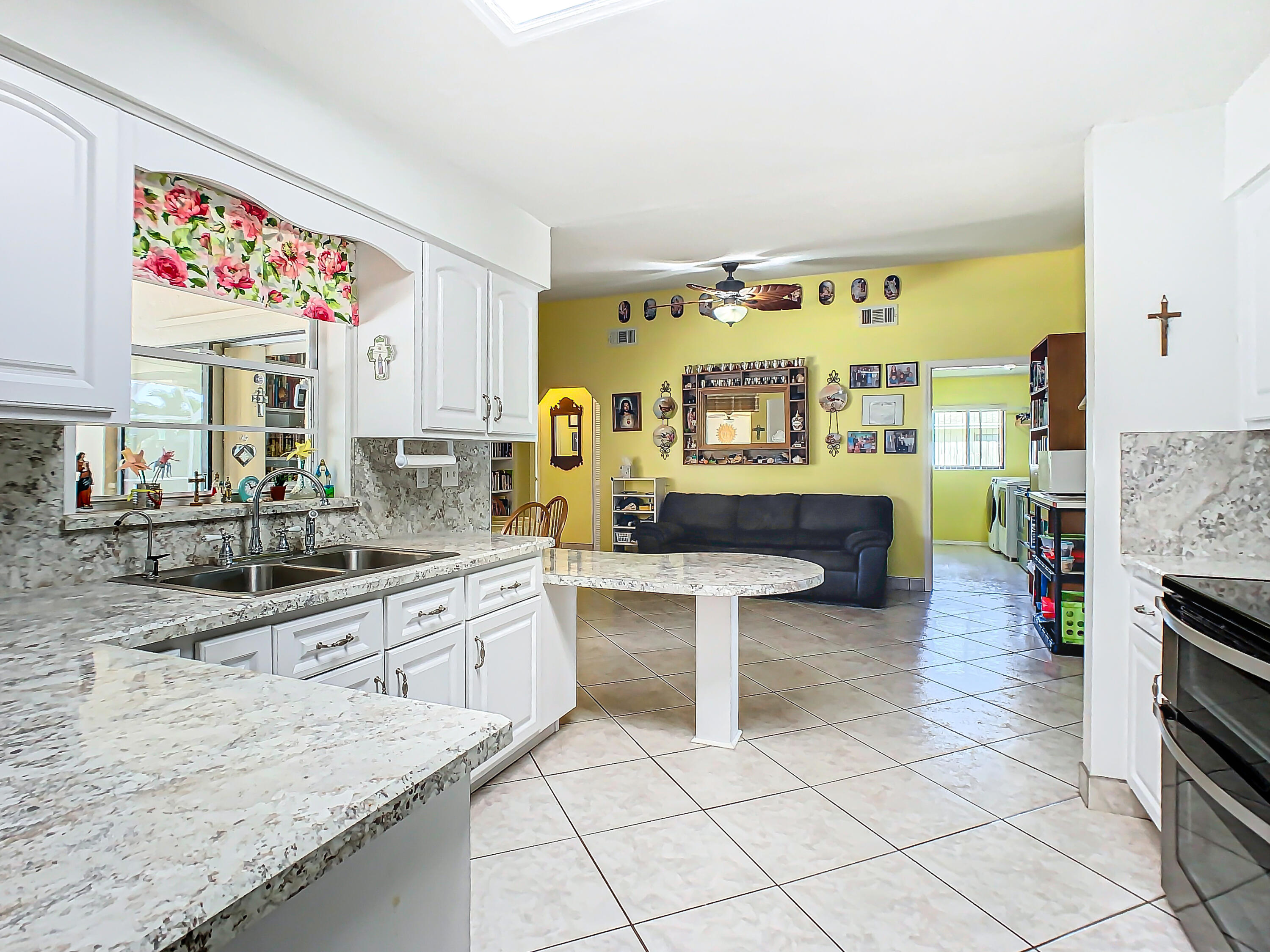 409 Surf Road Melbourne Beach, FL 32951 - Photo 9 of 34 a large white kitchen with a stove a sink and a refrigerator