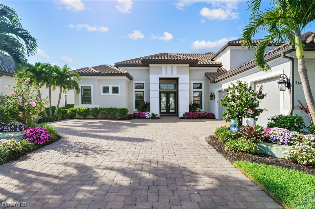 9345 Tulipano Terrace Naples, FL 34119 - Photo 1 of 50 a front view of a house with garden
