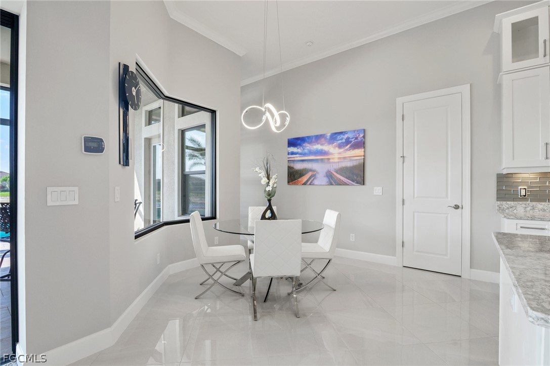 9345 Tulipano Terrace Naples, FL 34119 - Photo 12 of 50 a dining room with furniture and window