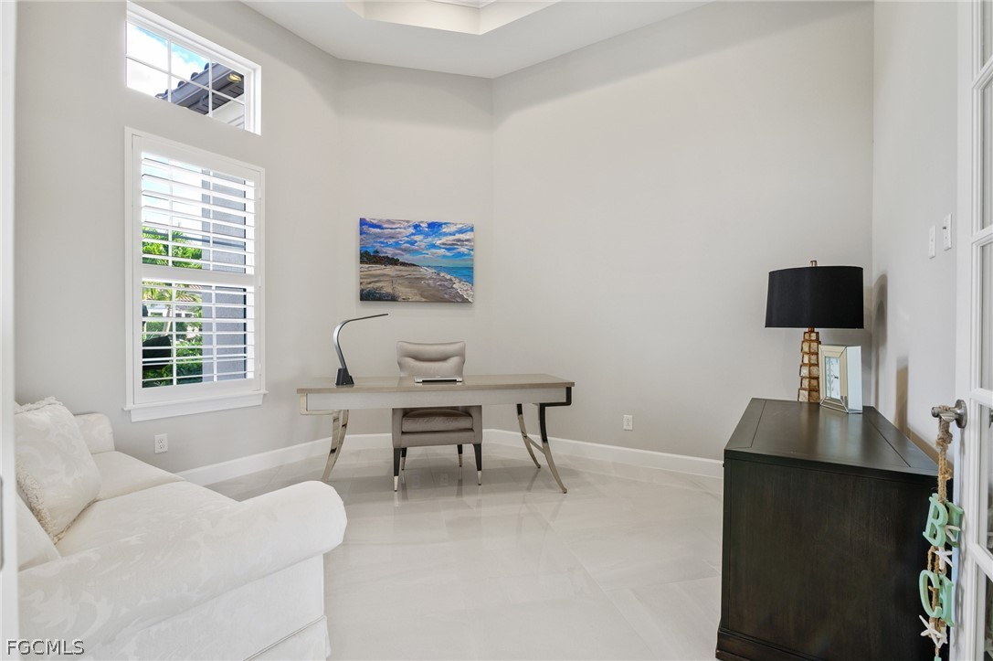 9345 Tulipano Terrace Naples, FL 34119 - Photo 16 of 50 a work room with furniture a rug and a window