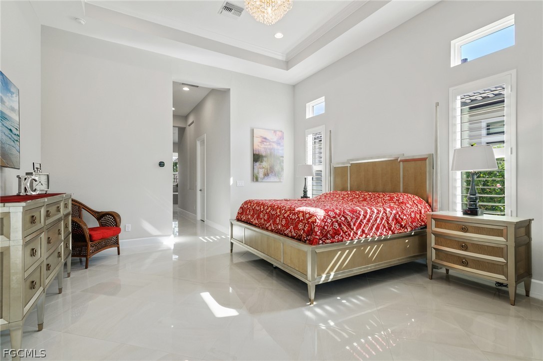 9345 Tulipano Terrace Naples, FL 34119 - Photo 18 of 50 a bedroom with a bed and a window