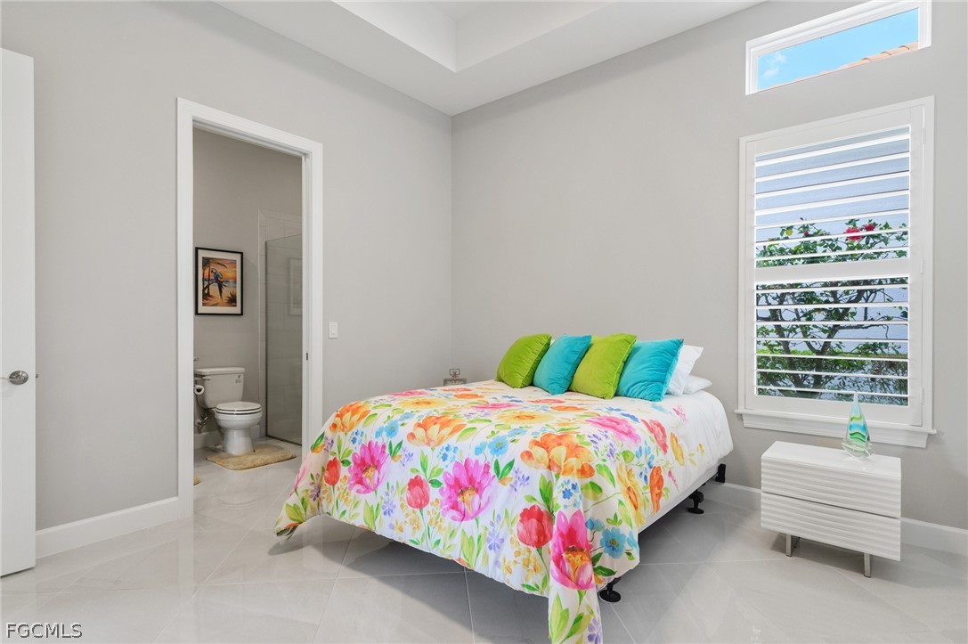 9345 Tulipano Terrace Naples, FL 34119 - Photo 22 of 50 a bedroom with a bed and a couch