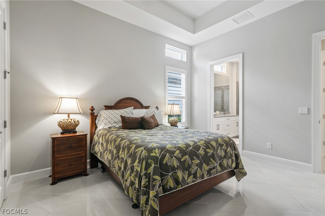 9345 Tulipano Terrace Naples, FL 34119 - Photo 25 of 50 a bedroom with a bed and window