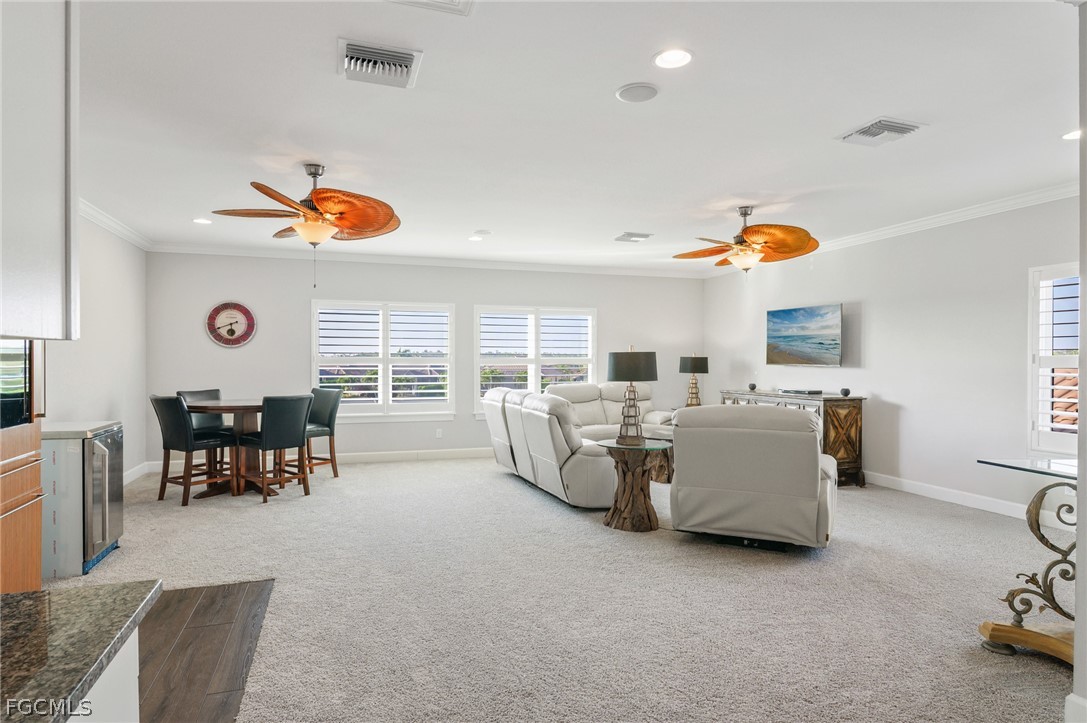 9345 Tulipano Terrace Naples, FL 34119 - Photo 30 of 50 a living room with couches and kitchen view with a dining table