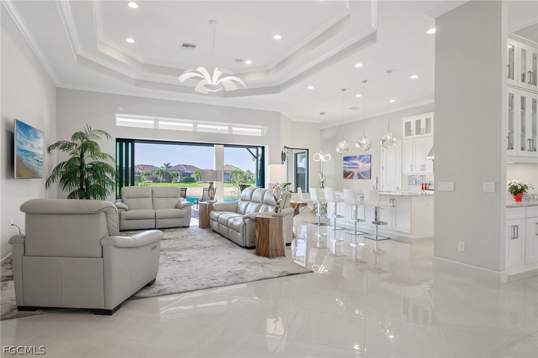 9345 Tulipano Terrace Naples, FL 34119 - Photo 3 of 50 a living room with furniture and a large window