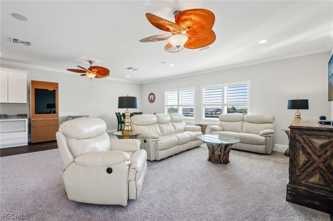 9345 Tulipano Terrace Naples, FL 34119 - Photo 32 of 50 a living room with furniture and a large window
