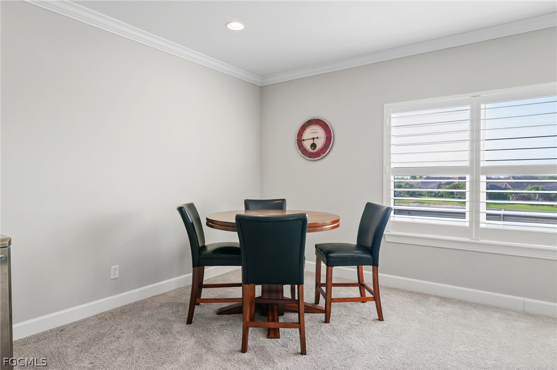 9345 Tulipano Terrace Naples, FL 34119 - Photo 34 of 50 a view of a dining room that has a table and chair