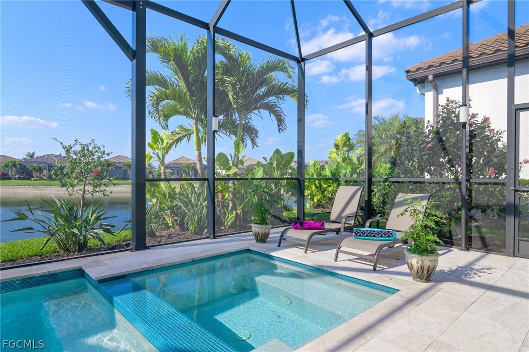 9345 Tulipano Terrace Naples, FL 34119 - Photo 39 of 50 a view of swimming pool with a lounge chairs