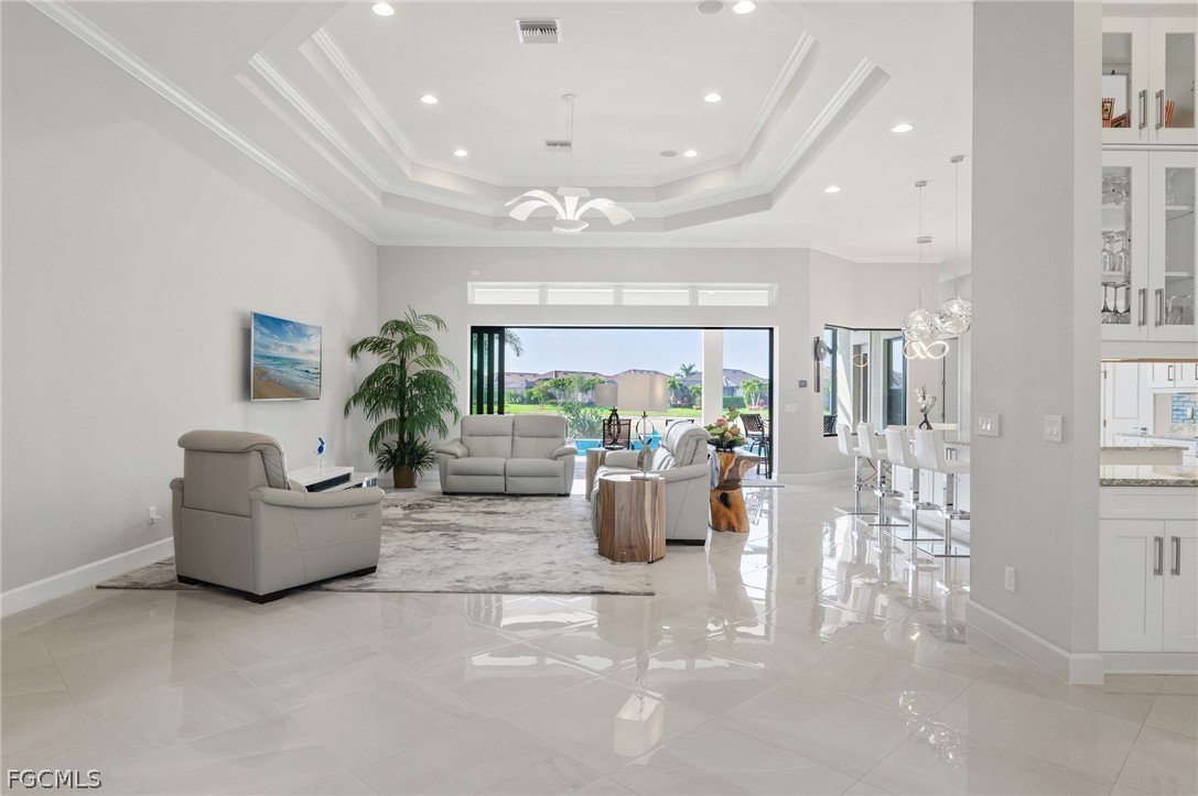9345 Tulipano Terrace Naples, FL 34119 - Photo 4 of 50 a living room with furniture and a large window
