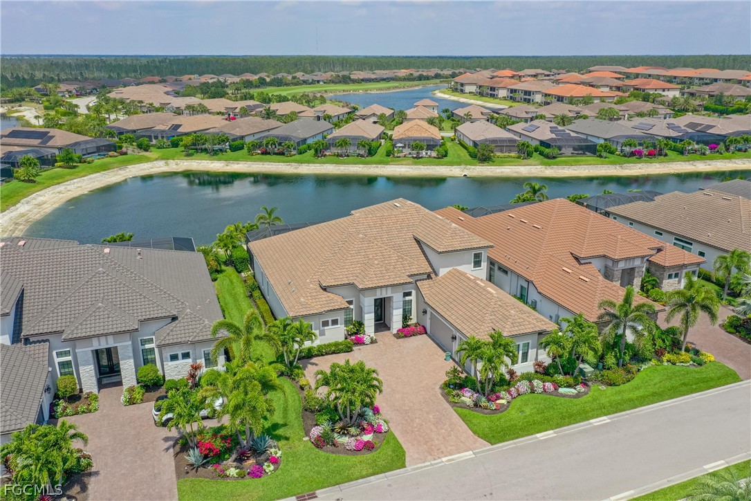 9345 Tulipano Terrace Naples, FL 34119 - Photo 44 of 50 an aerial view of a house with a garden and lake view