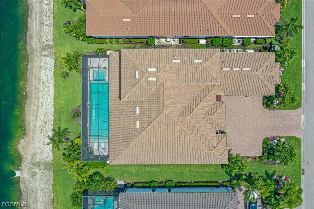 9345 Tulipano Terrace Naples, FL 34119 - Photo 46 of 50 an aerial view of a house with a garden and a yard