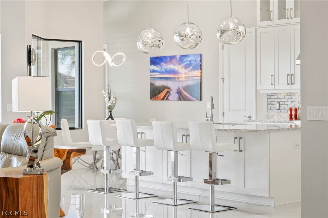 9345 Tulipano Terrace Naples, FL 34119 - Photo 6 of 50 a view of dining room and hall with wooden floor