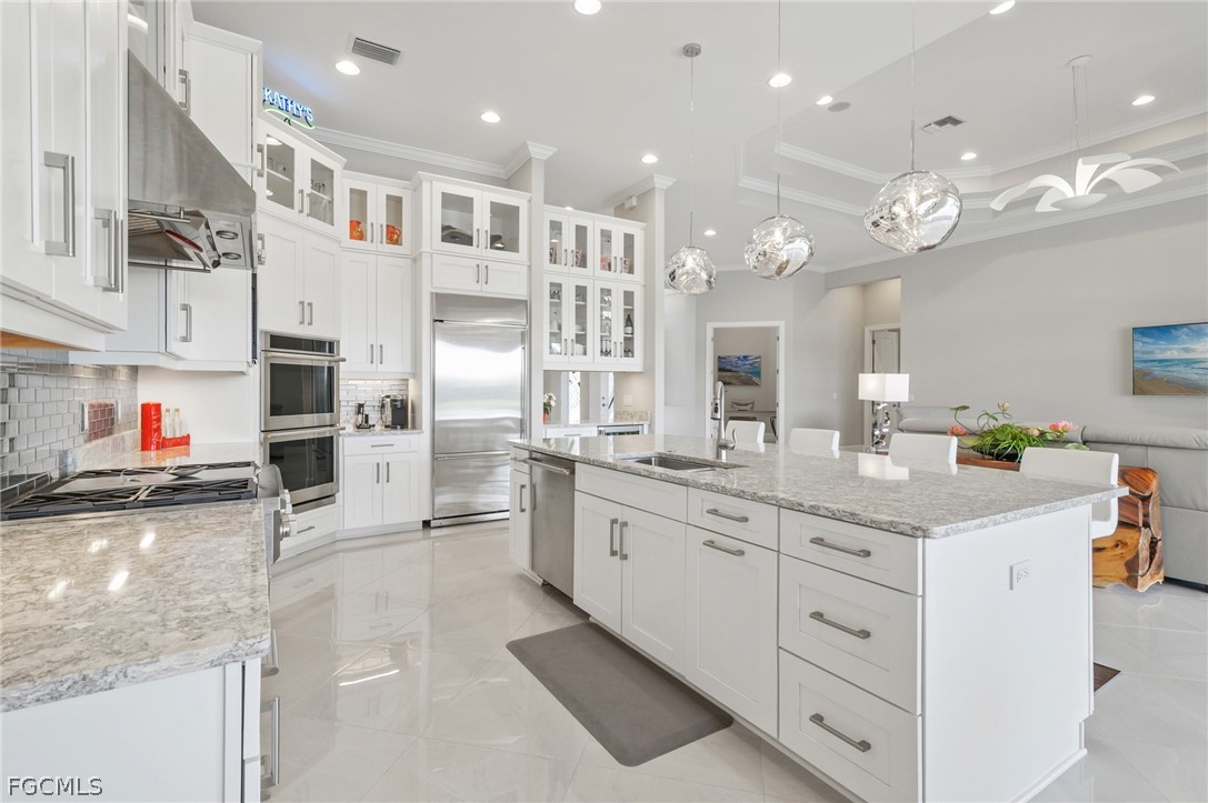 9345 Tulipano Terrace Naples, FL 34119 - Photo 7 of 50 a kitchen with cabinets and window