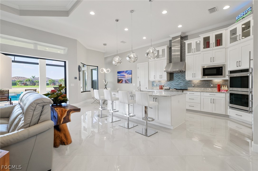 9345 Tulipano Terrace Naples, FL 34119 - Photo 10 of 50 a living room with stainless steel appliances furniture and a kitchen view