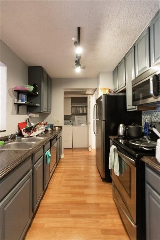 806 West 24th Street, Unit 314 Austin, TX 78705 - Photo 11 of 16 a large kitchen with stainless steel appliances granite countertop a stove refrigerator and a microwave