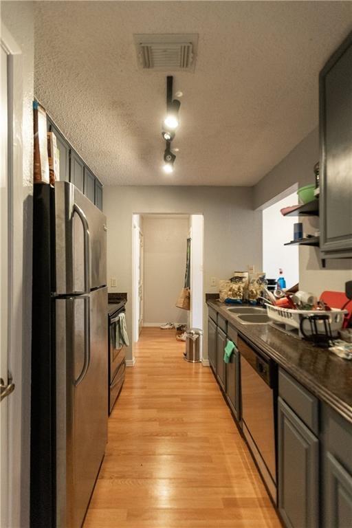 806 West 24th Street, Unit 314 Austin, TX 78705 - Photo 12 of 16 a kitchen with stainless steel appliances granite countertop a refrigerator stove and sink