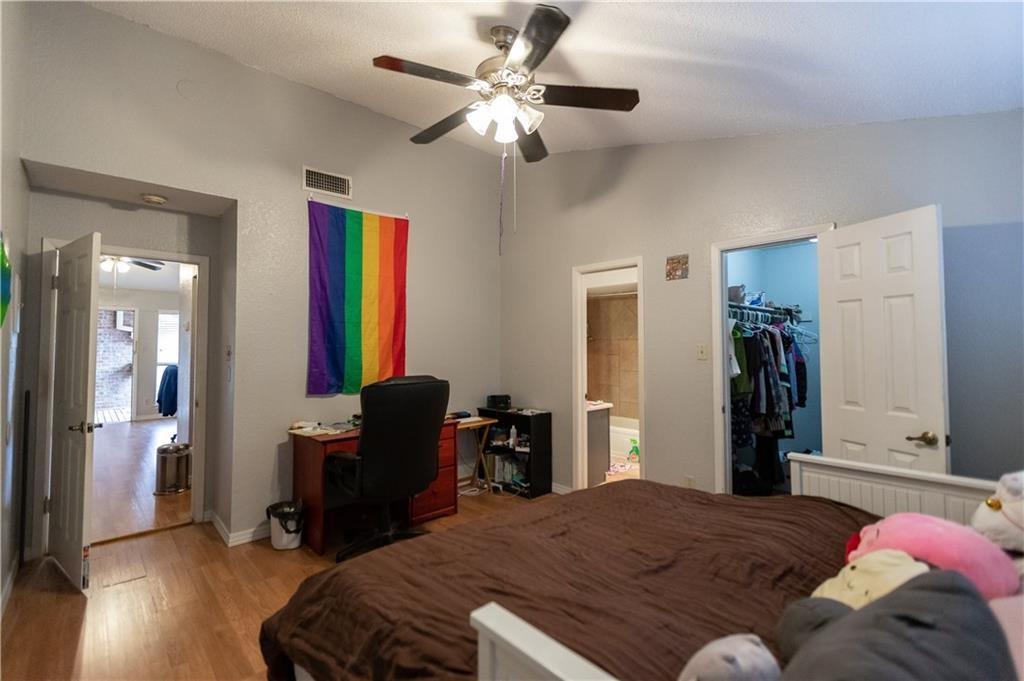 806 West 24th Street, Unit 314 Austin, TX 78705 - Photo 6 of 16 a bedroom with a bed and a chandelier