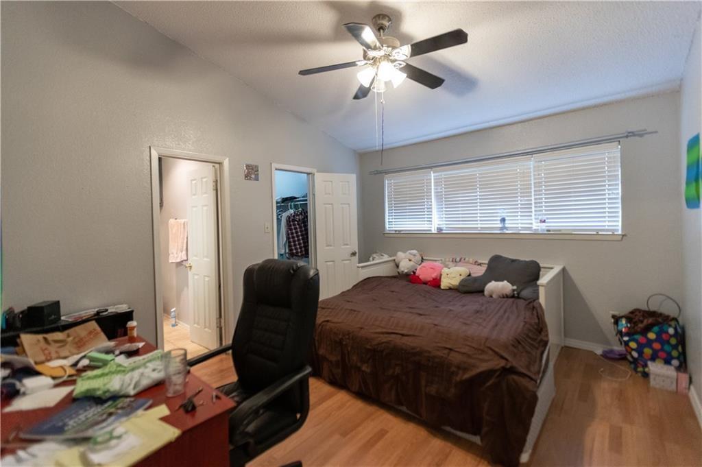 806 West 24th Street, Unit 314 Austin, TX 78705 - Photo 7 of 16 a bedroom with a bed and wooden floor