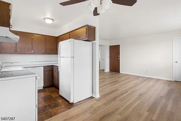 a kitchen with a refrigerator a microwave and cabinets