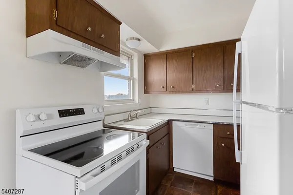 a kitchen with a stove cabinets and a refrigerator