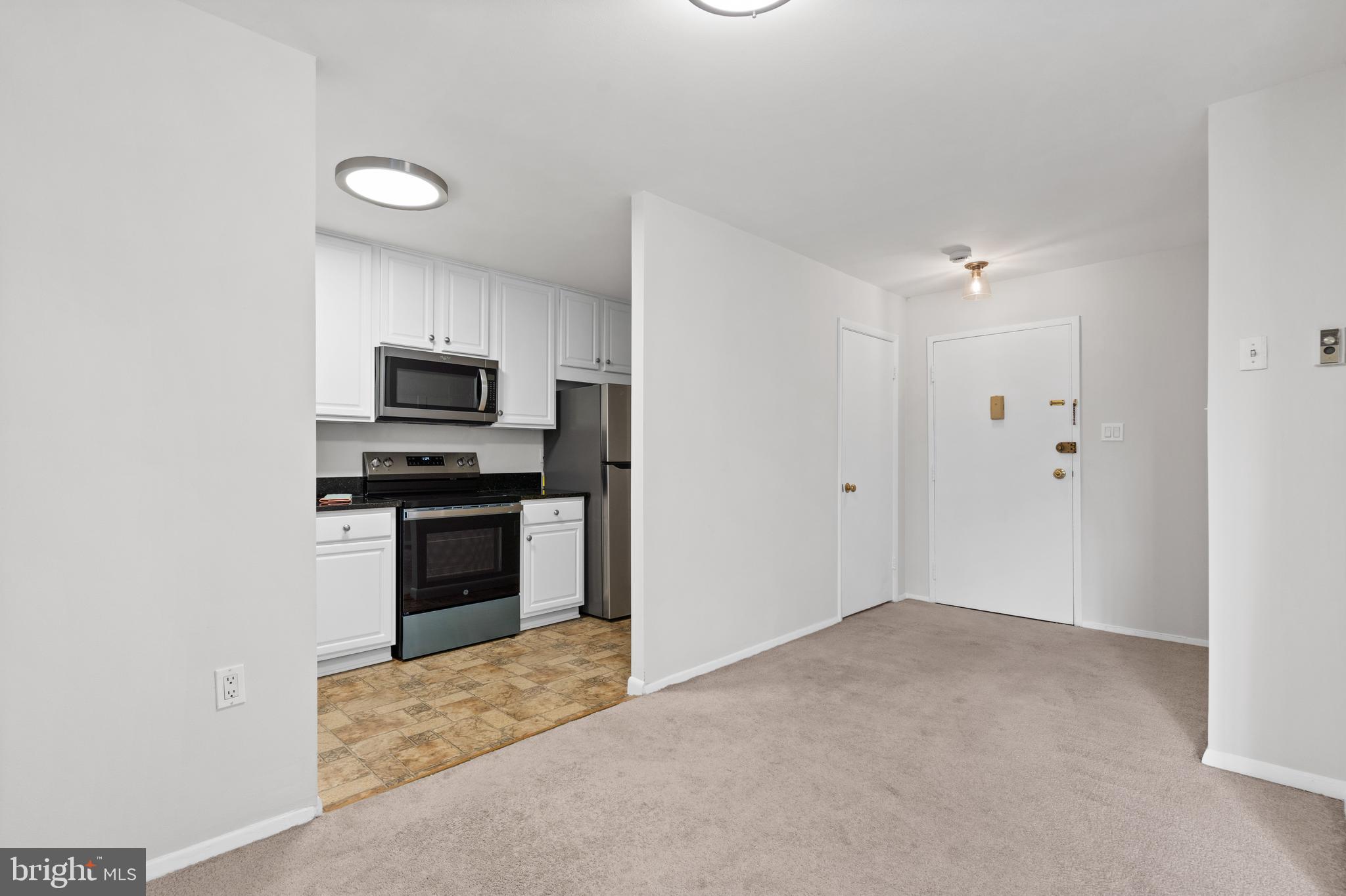 3245 Rio Drive, Unit 714 Falls Church, VA 22041 - Photo 11 of 30 a view of a kitchen with sink electronic appliances and window