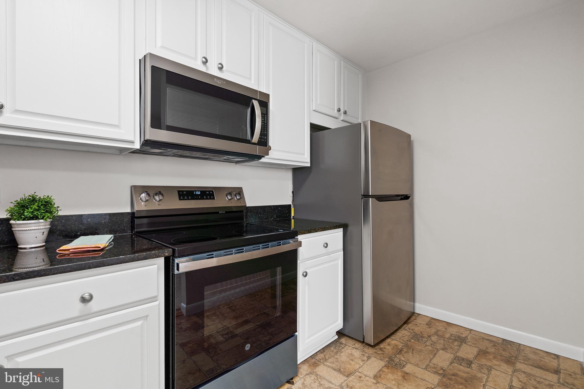 3245 Rio Drive, Unit 714 Falls Church, VA 22041 - Photo 15 of 30 a kitchen with stainless steel appliances a stove microwave and refrigerator