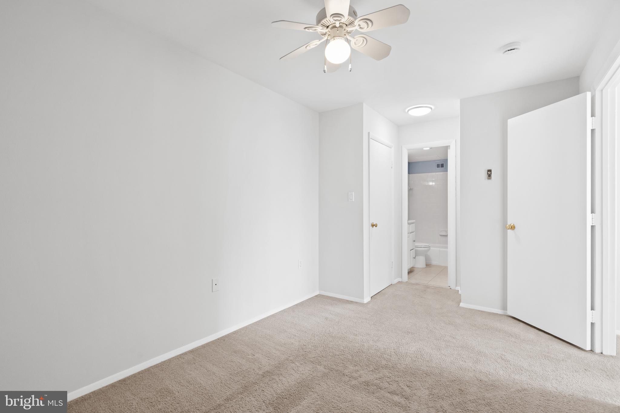 3245 Rio Drive, Unit 714 Falls Church, VA 22041 - Photo 26 of 30 a view of an empty room and a bathroom with a fan