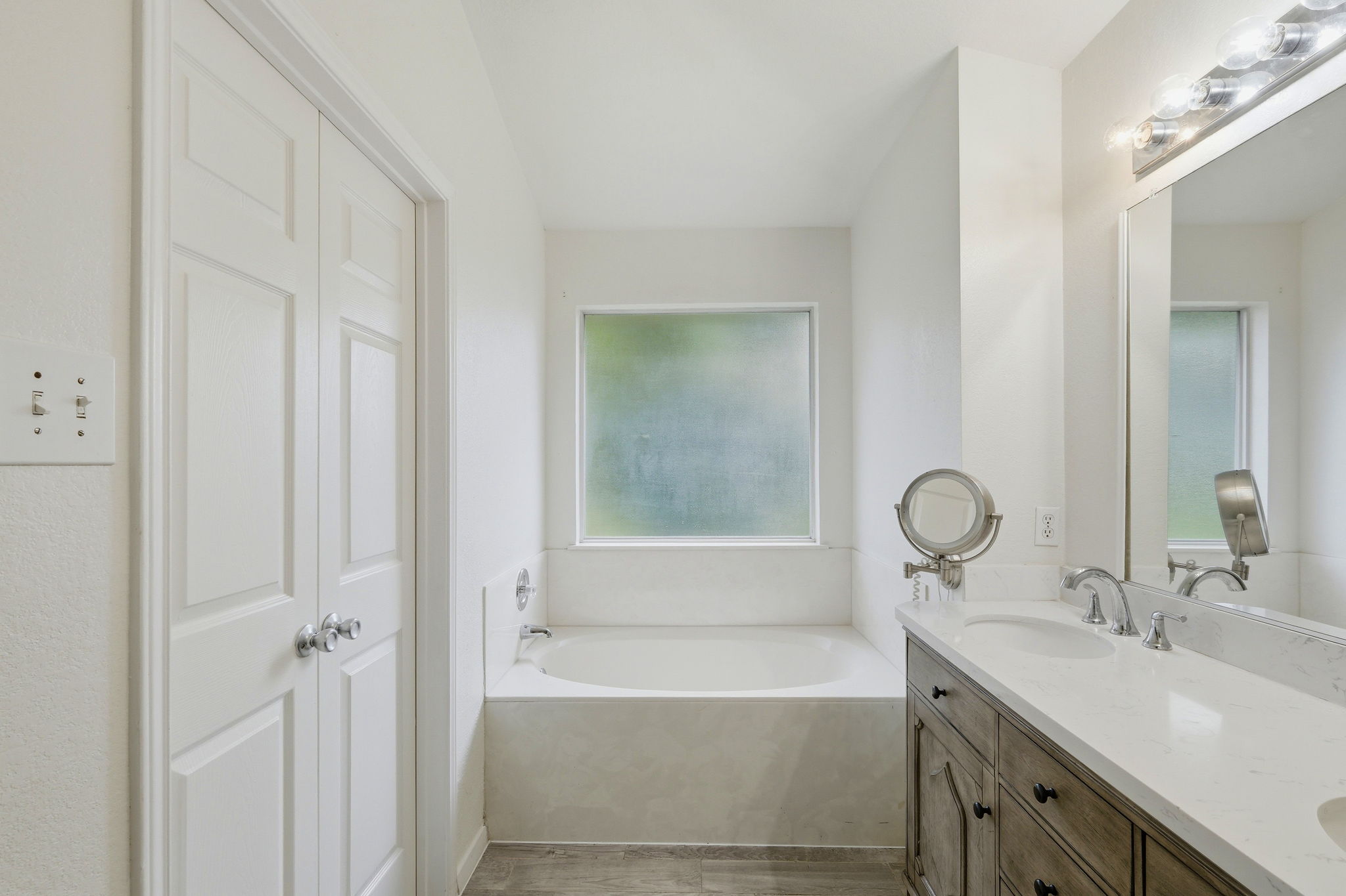 1005 Rolling Ridge Drive Round Rock, TX 78665 - Photo 8 of 18 White walls and a large vanity with ample storage create a refreshing primary bath retreat.