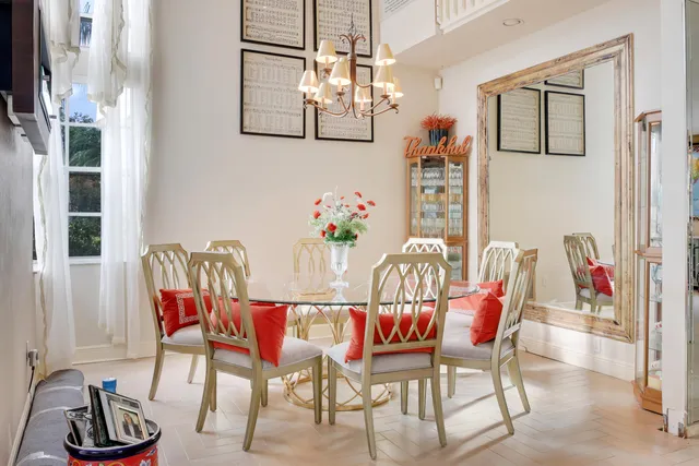 a dining room with furniture a rug and a chandelier
