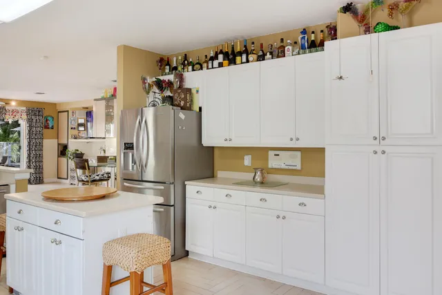 a kitchen with refrigerator and cabinets