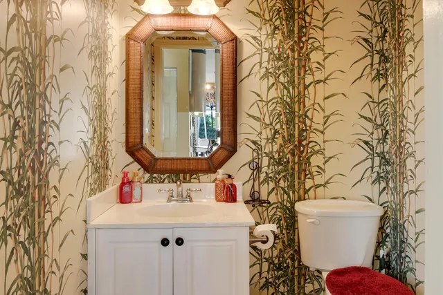 a bathroom with a sink and mirror with toilet