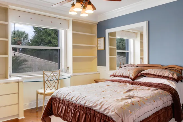a bedroom with a bed and wooden floor