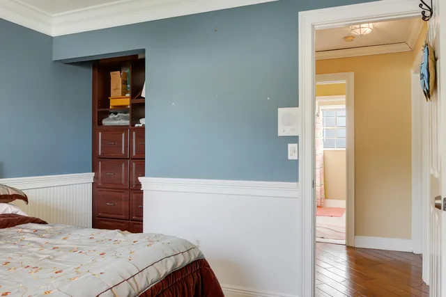 a bedroom with a bed and a dresser