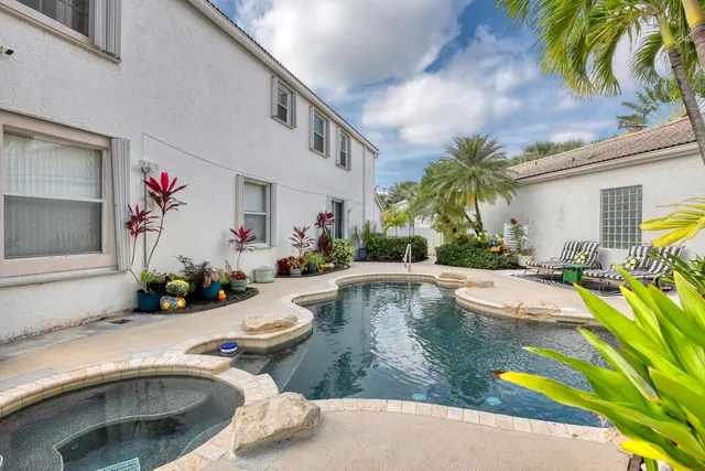 a view of a swimming pool with potted plants