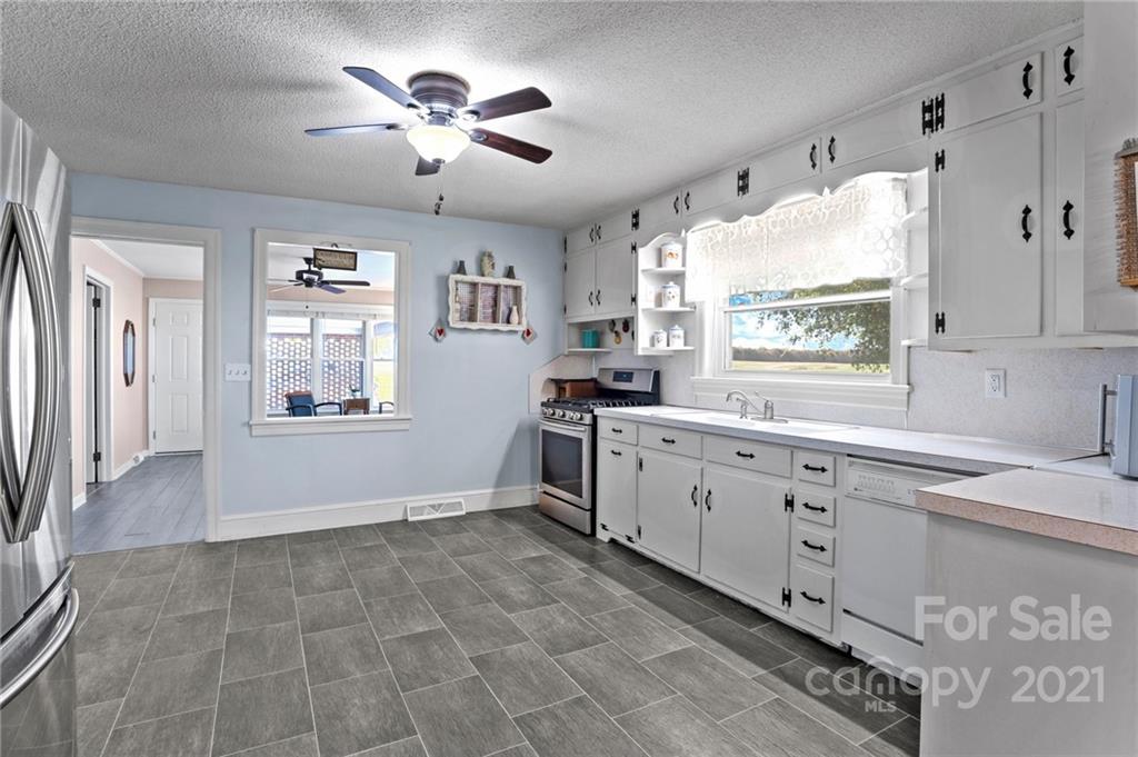 2125 Stack Road Monroe, NC 28112 - Photo 11 of 38 a kitchen with granite countertop a stove a sink a window and dining table