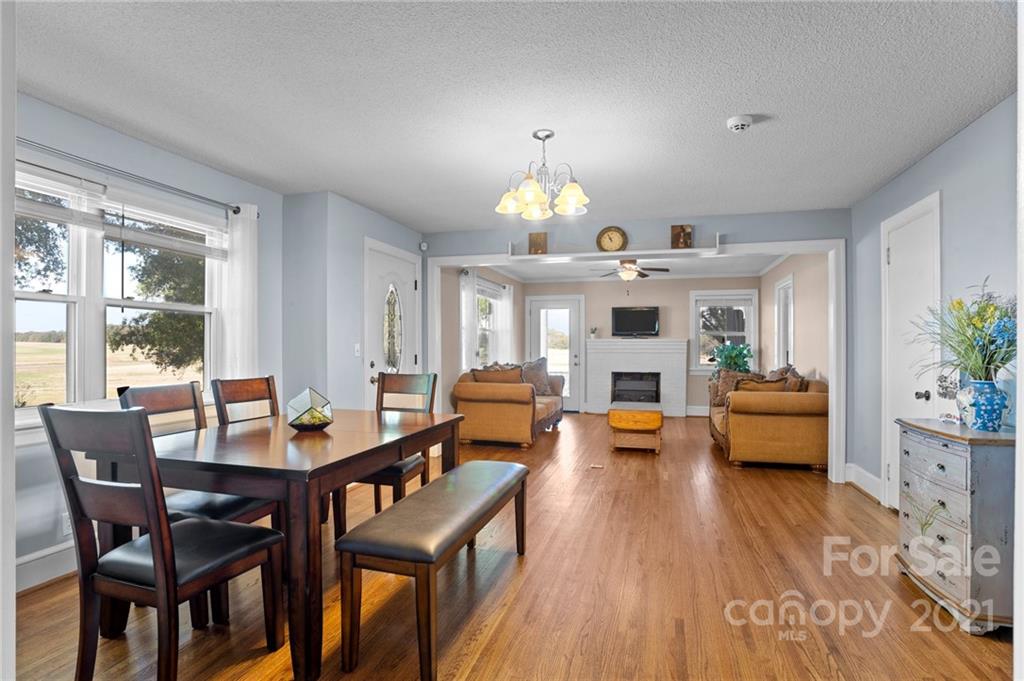 2125 Stack Road Monroe, NC 28112 - Photo 3 of 38 a view of a dining room with furniture a fireplace and wooden floor