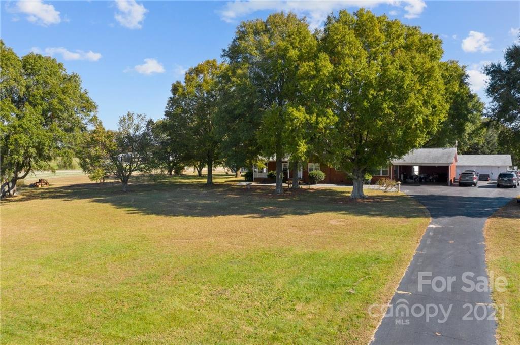2125 Stack Road Monroe, NC 28112 - Photo 24 of 38 a view of swimming pool with outdoor seating and trees in the background