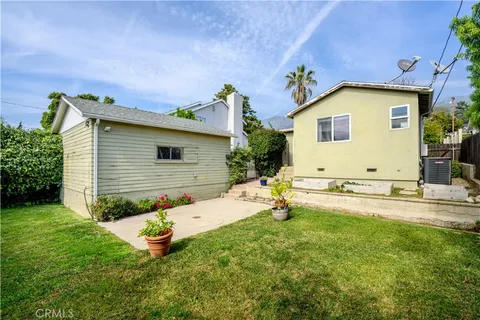 a view of a backyard with plants and a patio