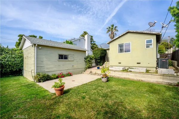 a view of a backyard with plants and a patio